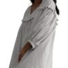 Model wearing white checkered babydoll dress with V neck puff sleeves and relaxed mini silhouette