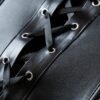 Close-up of a black strapless corset top featuring intricate lace-up details and sleek fabric