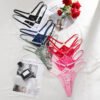 Colorful lace thongs for women in various shades arranged with roses and a magazine
