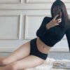Model wearing black sexy low waist panties for women paired with a fitted top in a stylish setting