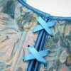 Close-up of a floral patterned Victorian corset top for women featuring blue laces and detailing