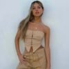 Stylish women's corset crop top in beige with lace-up front and strapless design