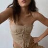 Beige women's corset crop top featuring lace-up details and a fitted design for a stylish look