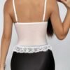Back view of a women's lace corset top with adjustable straps and lace trim